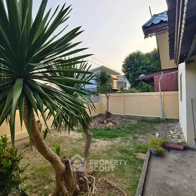 Charming garden view with lush greenery and spacious outdoor area, perfect for relaxation and leisure activities.