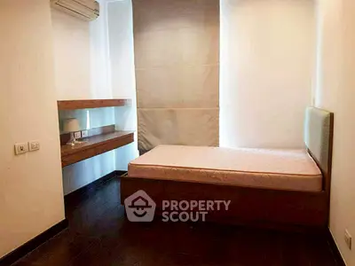 Cozy minimalist bedroom with single bed and wooden desk