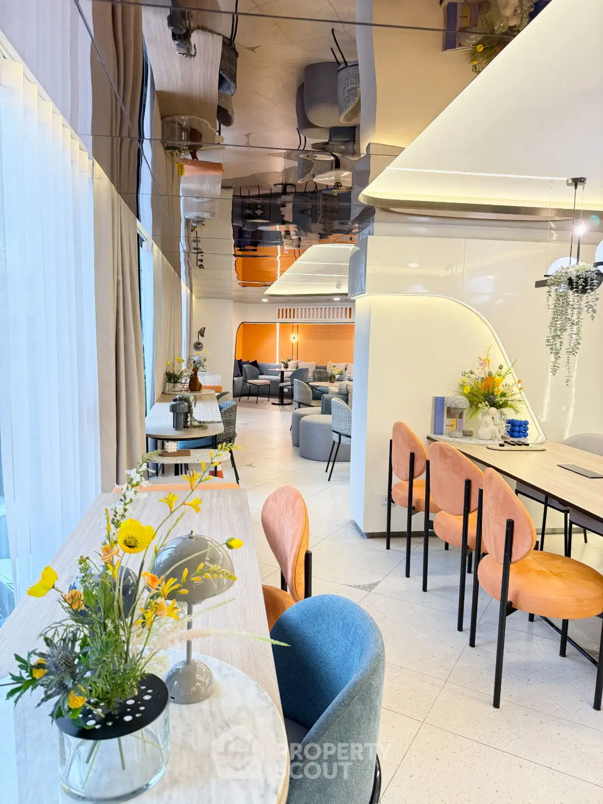 Modern open-plan living and dining area with stylish decor and vibrant seating.