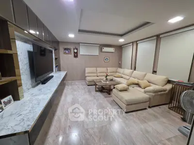 Spacious modern living room with marble flooring and cozy beige sectional sofa