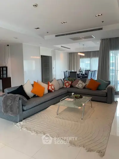 Spacious modern living room with stylish decor and large windows for natural light.