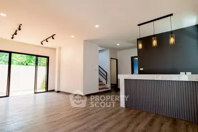 Spacious modern living room with open layout and stylish lighting, perfect for contemporary living.