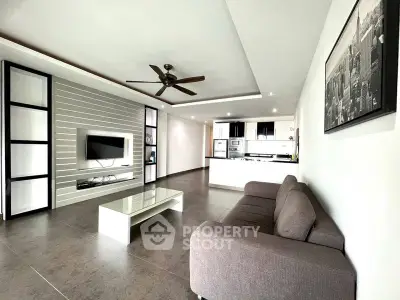 Spacious modern living room with open kitchen and stylish decor