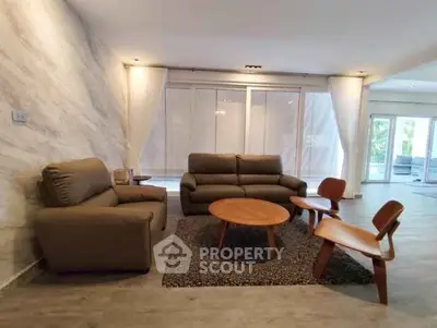 Spacious modern living room with stylish furniture and large windows
