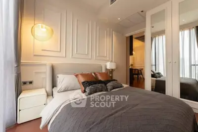 Luxurious bedroom with elegant decor and mirrored wardrobe in modern apartment