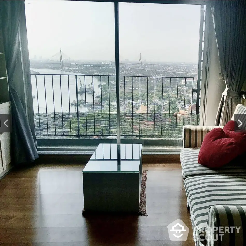 Stunning high-rise apartment with panoramic river view and cozy living area.