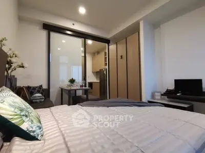 Modern studio apartment with cozy bedroom and open kitchen layout