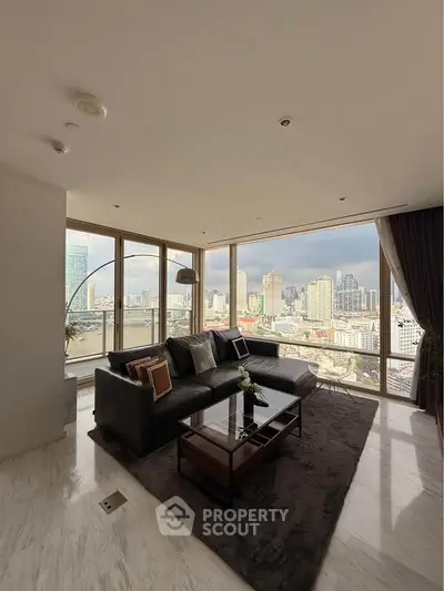 Luxurious corner unit living room with panoramic city views and elegant furnishings.
