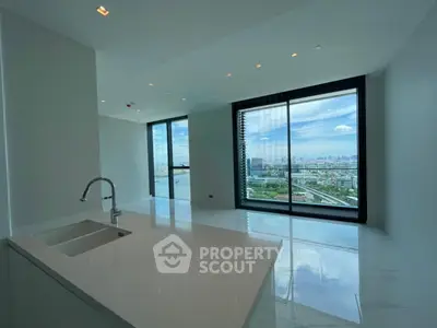 Luxurious modern apartment with stunning city view and sleek open kitchen layout.
