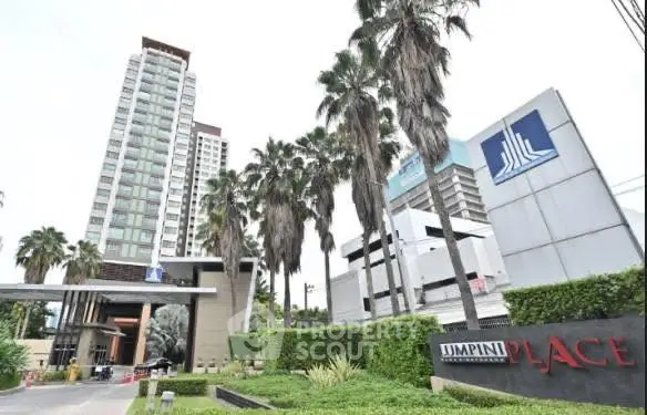 Modern high-rise building with lush landscaping and prominent signage in a prime location.