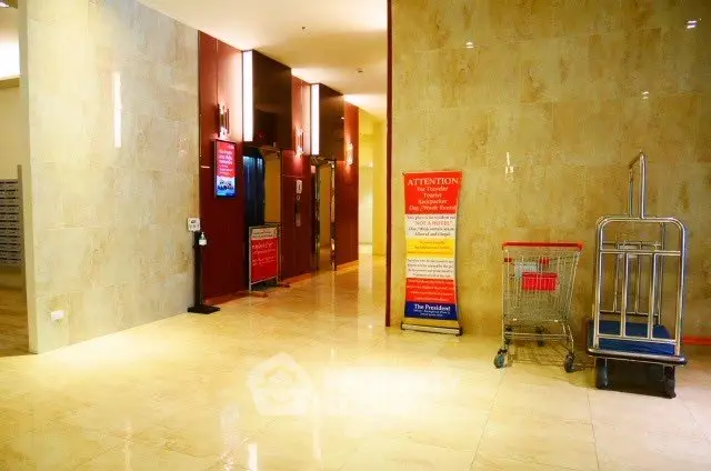 Luxurious building entrance with polished floors and modern design.
