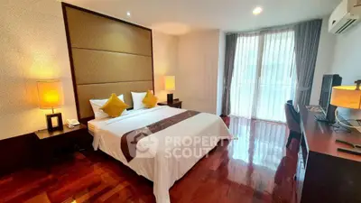 Luxurious bedroom with elegant decor and natural light, featuring a comfortable bed and stylish furnishings.