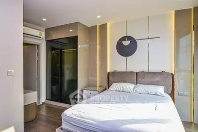 Modern bedroom with stylish decor and ample natural light