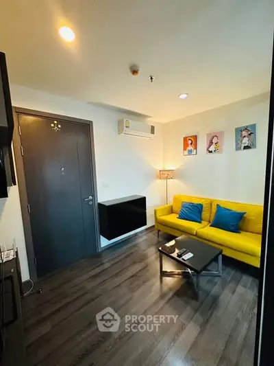 Modern living room with yellow sofa and stylish decor in a cozy apartment.