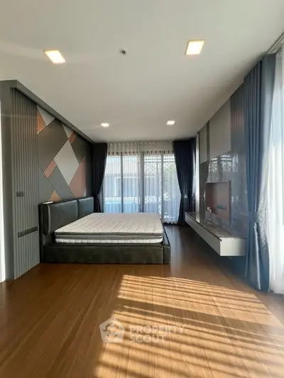 Luxurious bedroom with modern design, featuring large windows and elegant decor.