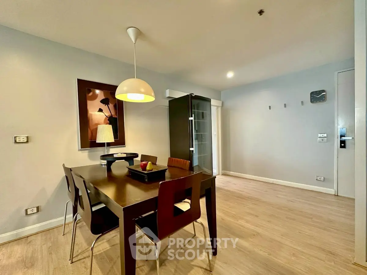 Modern dining area with sleek furniture and ambient lighting in a stylish apartment.