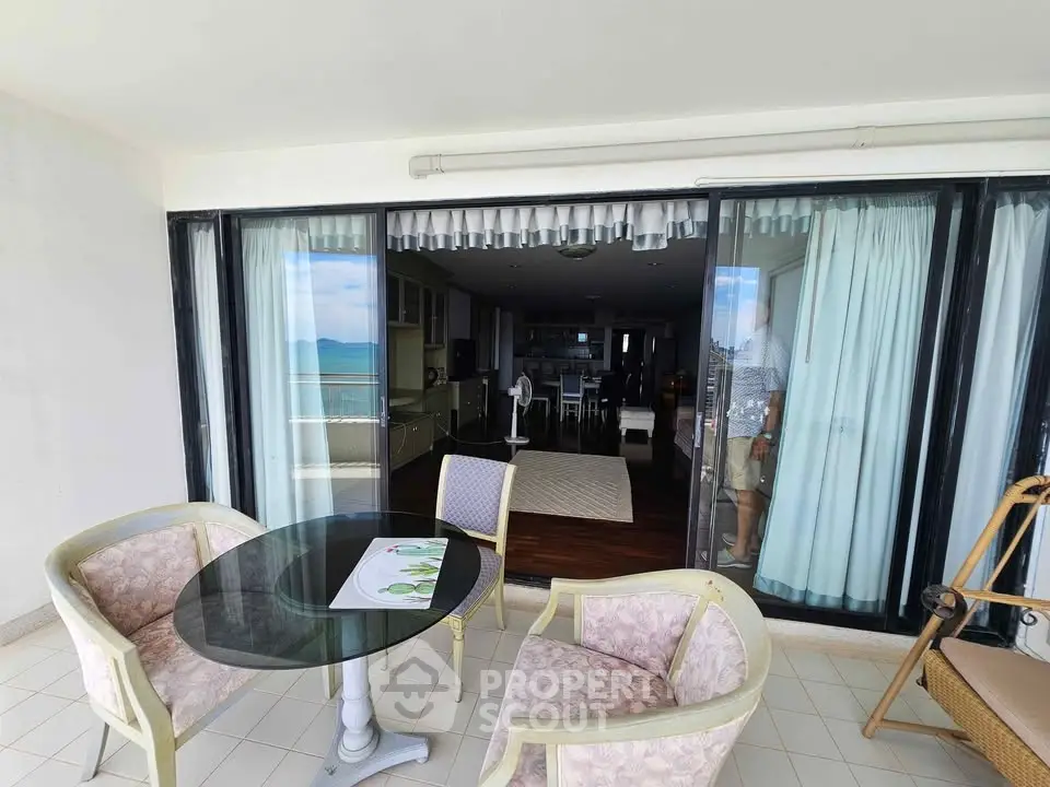 Spacious balcony with ocean view and stylish outdoor seating