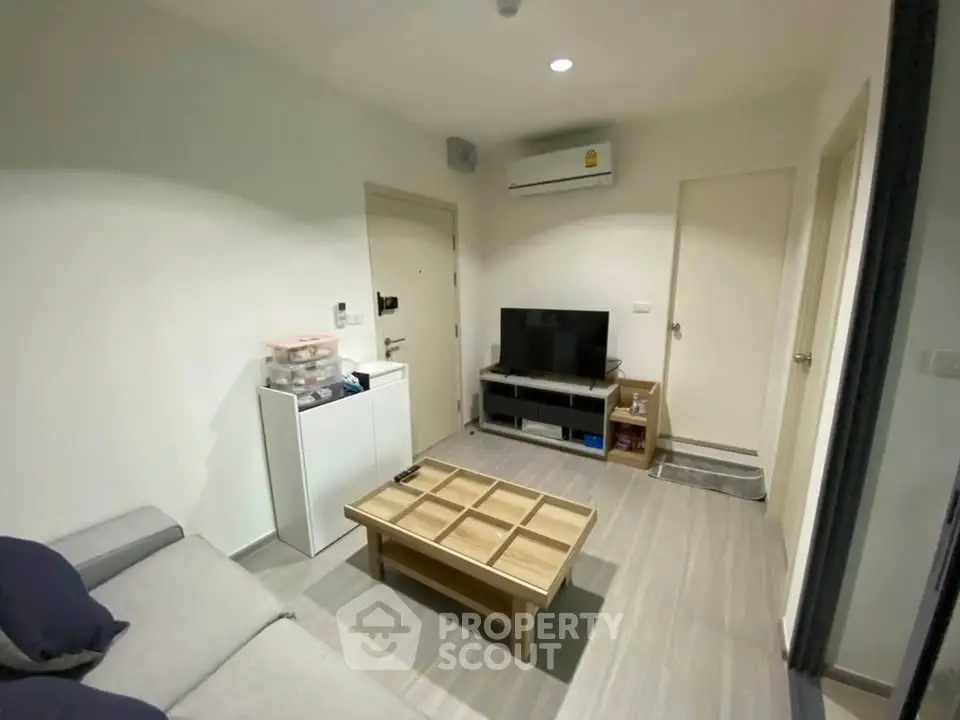 Modern living room with sleek furniture and air conditioning, perfect for comfortable living.