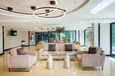 Luxurious modern living room with elegant furniture and stylish lighting in a bright, spacious setting.