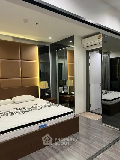 Luxurious modern bedroom with mirrored walls and elegant lighting