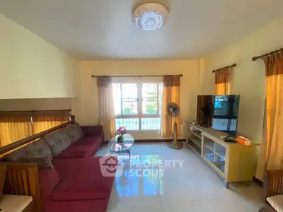 Cozy living room with large windows and modern furnishings