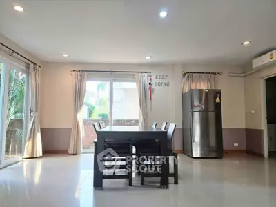 Spacious dining area with natural light and modern decor in a stylish home.