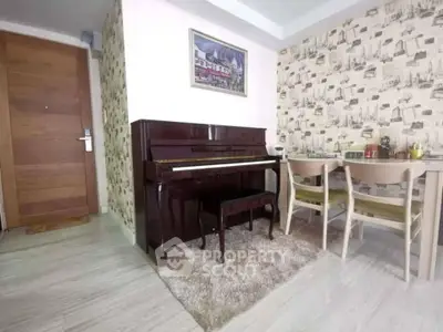 Charming living room with piano and dining area, featuring stylish wallpaper and wooden flooring.