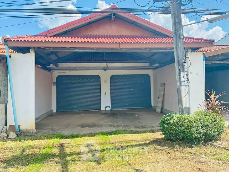 Charming single-story house with dual garage doors and a spacious driveway, perfect for family living.