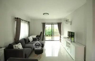 Spacious living room with modern furniture and large windows offering natural light