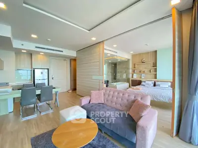 Spacious modern living room with open layout and stylish furniture in a luxury apartment.