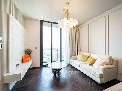 Elegant living room with modern chandelier and large windows offering city views.