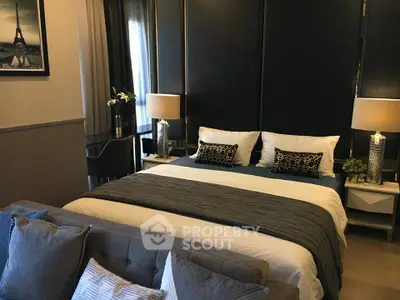Luxurious bedroom with elegant decor and plush bedding in a modern apartment.