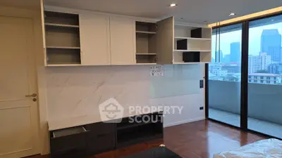 Modern living room with open cabinets and city view balcony