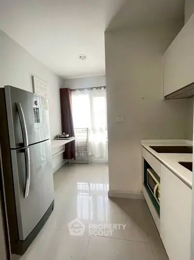 Modern kitchen with sleek appliances and natural light, perfect for culinary enthusiasts.