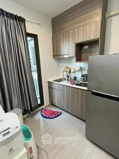 Modern kitchen with sleek cabinetry and stainless steel appliances in a compact layout