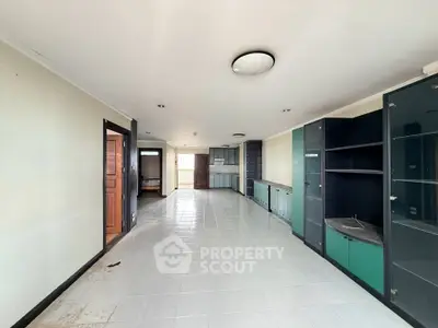 Spacious open-plan living area with modern cabinetry and ample natural light.