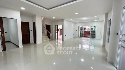 Spacious modern living room with glossy tile flooring and large windows