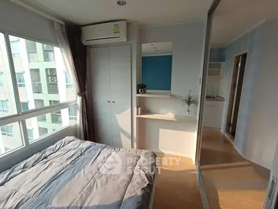 Bright bedroom with large windows and modern decor in a stylish apartment.