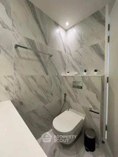 Modern bathroom with sleek marble tiles and minimalist design.