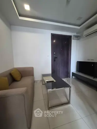 Modern living room with sleek furniture and air conditioning, perfect for cozy relaxation.