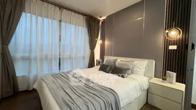 Modern bedroom with stylish decor and large window for natural light