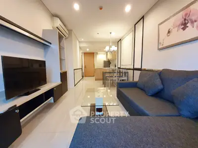 Modern living room with sleek furniture and elegant lighting in a stylish apartment.