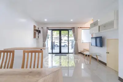 Spacious modern living room with sleek design and large windows for natural light.