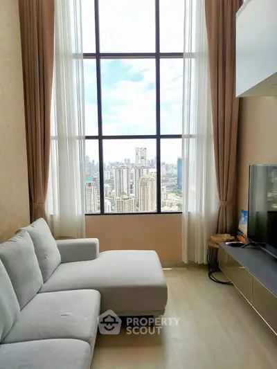 Luxurious living room with floor-to-ceiling windows offering stunning city views, featuring a modern sofa and entertainment unit.