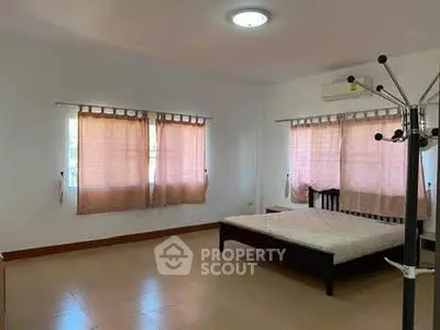 Spacious bedroom with natural light and minimalist decor