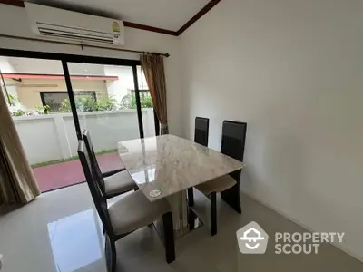 Modern dining area with marble table and garden view in stylish home