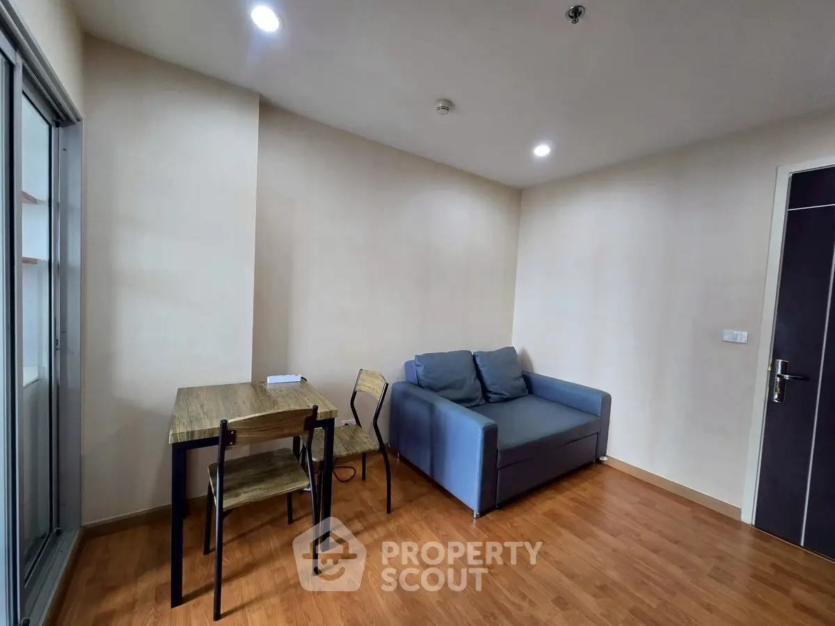 Cozy living room with modern sofa and dining area, perfect for urban living.