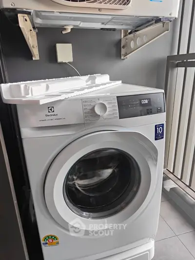 Modern washing machine on a balcony with sleek design and energy efficiency.