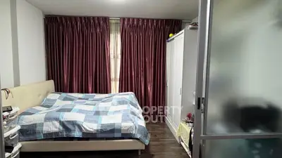 Cozy bedroom with stylish curtains and modern furniture, perfect for relaxation.