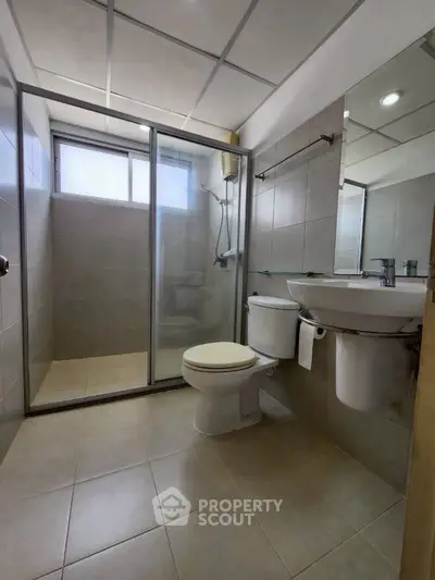 Modern bathroom with glass shower and sleek fixtures